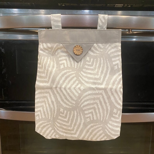 Wet bag handing from from of stove