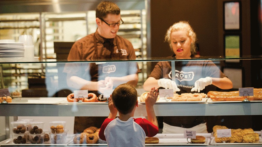 young child picking a doughnut flavor at Frost, a Seattle-area doughnut shop