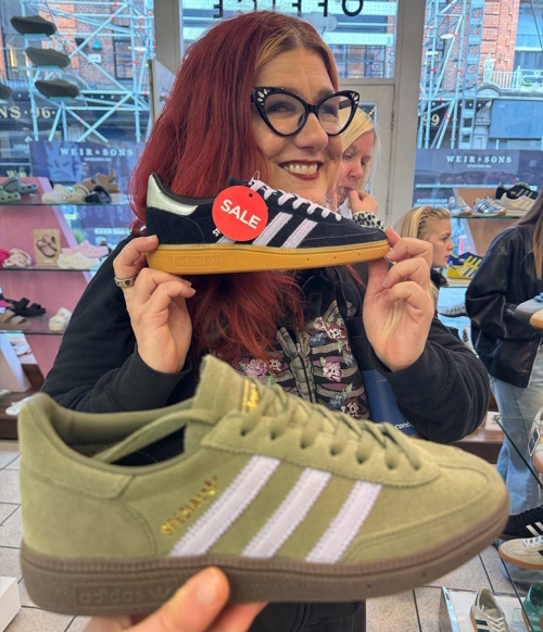 The author holding up new shoes they bought in Ireland