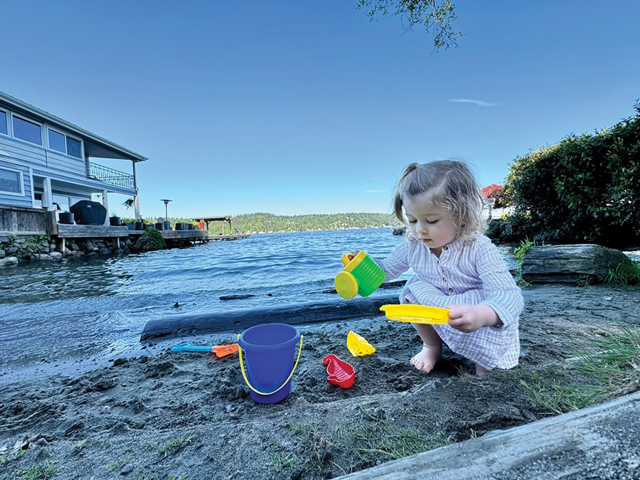 Little girl playing at a secret beach in Seattle