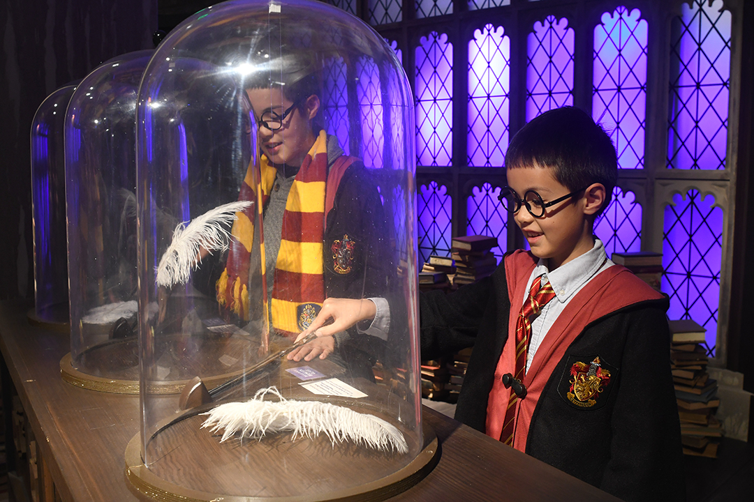 At Harry Potter: Magic at Play boys practice their wingardium leviosa spell in the Charms class at Hogwarts