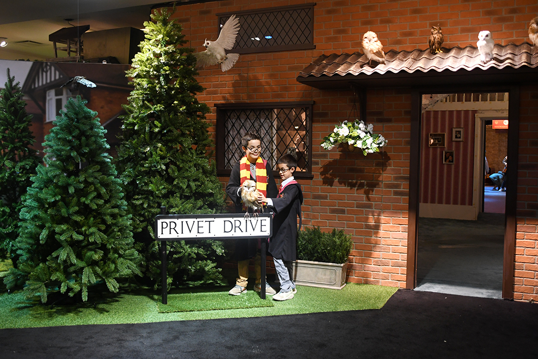 At Harry Potter: Magic at Play in Seattle boys pose in front of 4 Privet Drive Dursleys' house