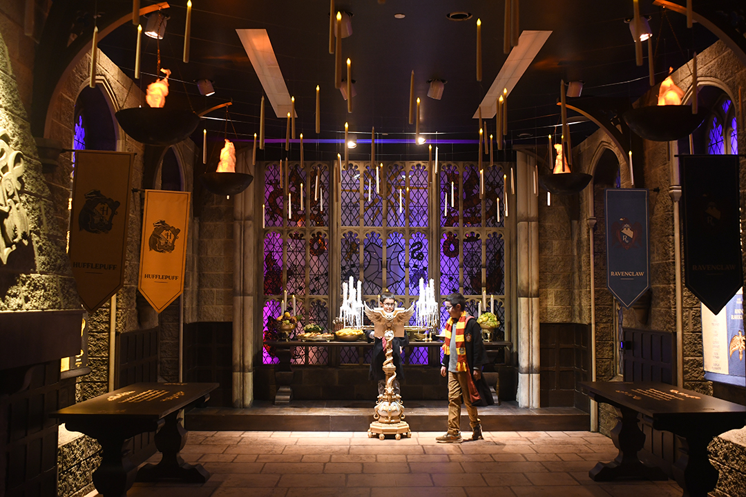 At Harry Potter: Magic at Play in Seattle boys examine the Great Hall of Hogwarts