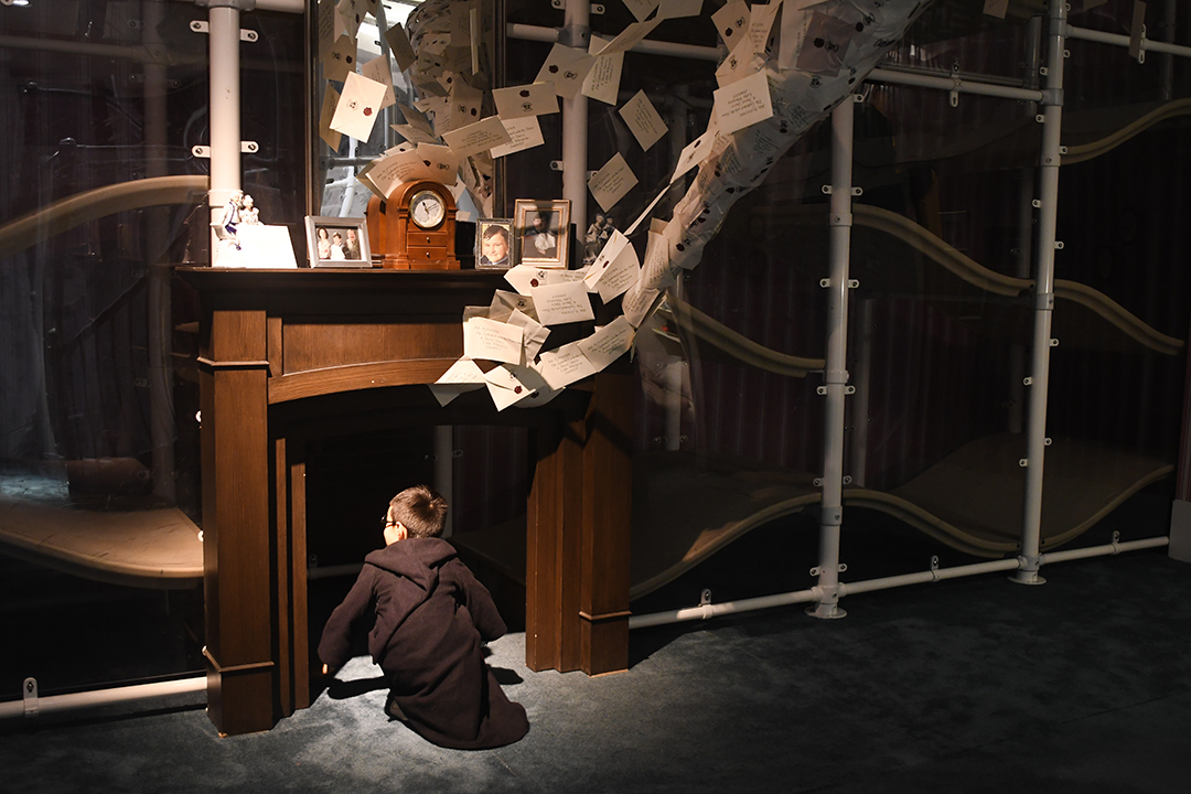 At Harry Potter: Magic at Play in Seattle a child enters the chimney at the Dursleys' house