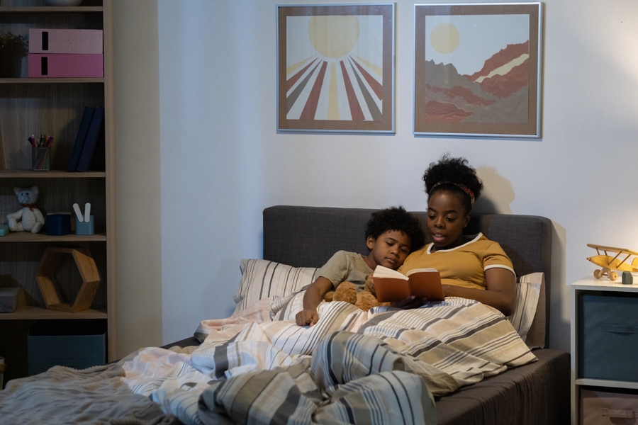 mom reading to son in bed