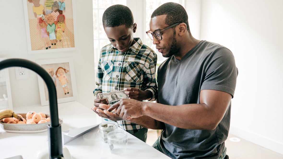 Dad teaching son financial literacy