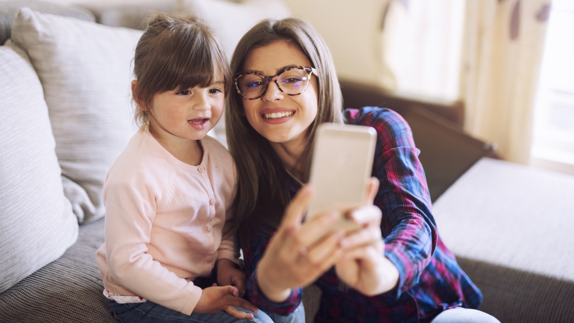 Nanny taking a selfie with a child in her care