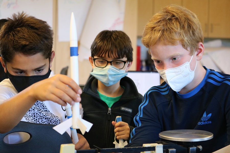 Three sixth-grade students from University Prep work together on a science experiment