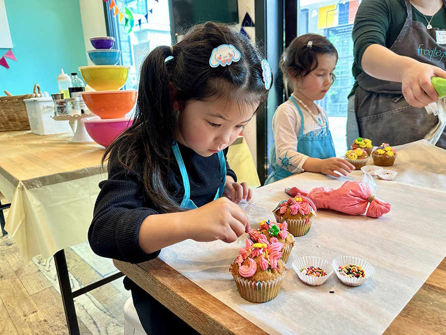 A child makes a cupcake at a sensory play spot in Seattle