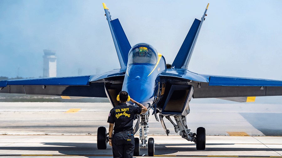 U.S. Navy Blue Angels crew member saluting pilot for Seattle Seafair Air Show