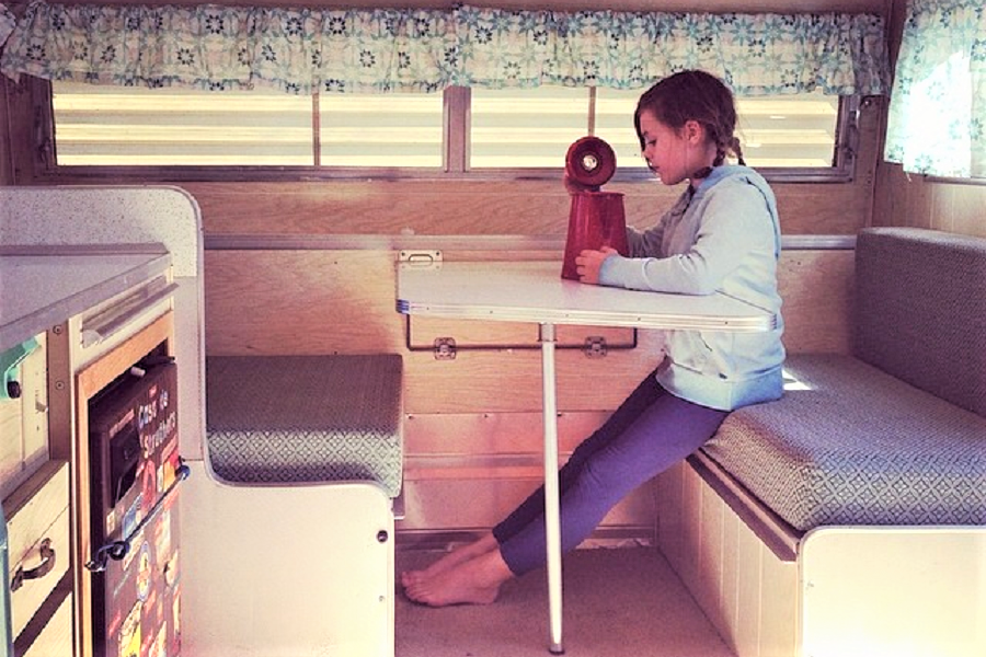 Relaxing in a vintage camping trailer