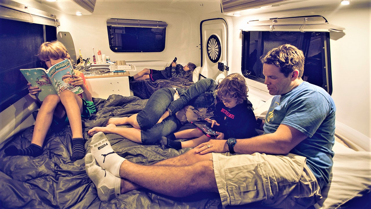 Relaxing inside a camping trailer