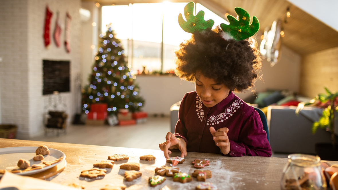 child decorating Christmas cookies
