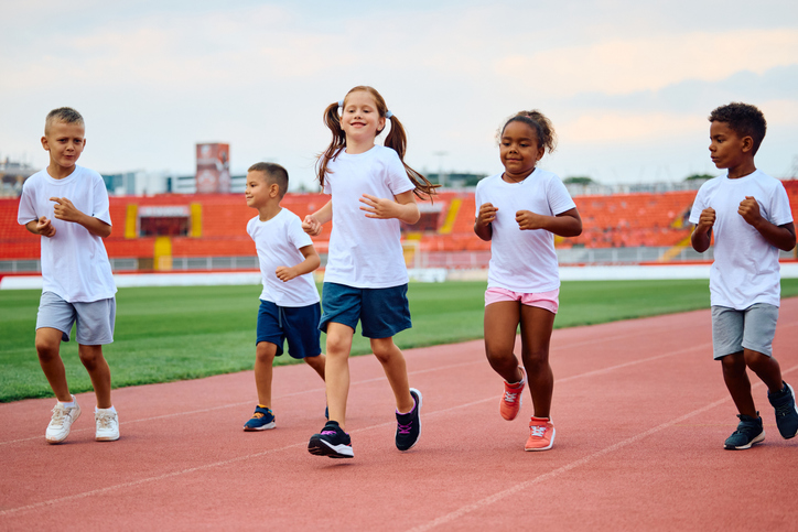 kids running on a track playing an Olympics-inspired game