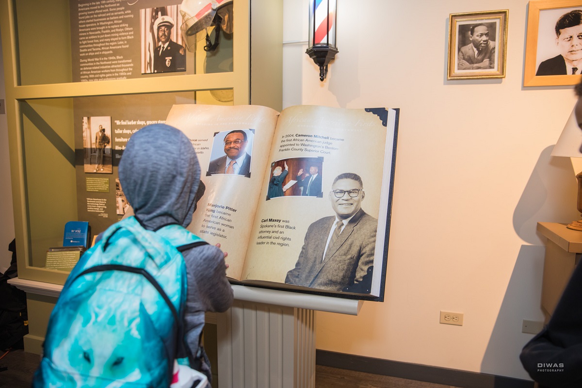 A girl looks at displays at the newly reopened Northwest African American Museum in Seattle