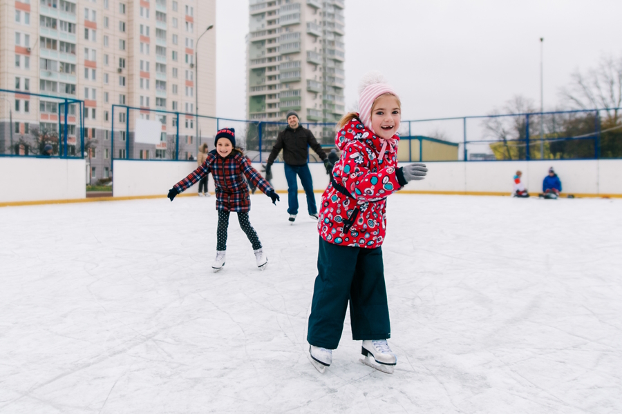 A girl at a holiday outdoor ice skating rink near Seattle