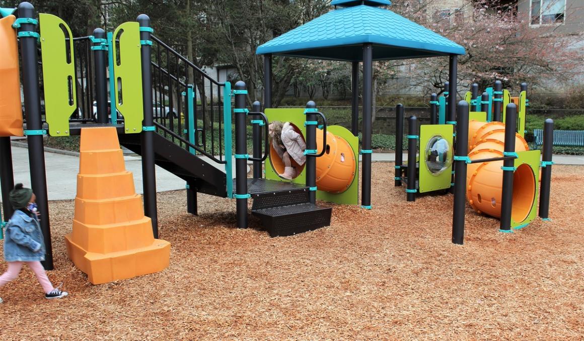 View of new play equipment children playing at Gene Coulon Memorial Beach Park Renton Washington near Seattle