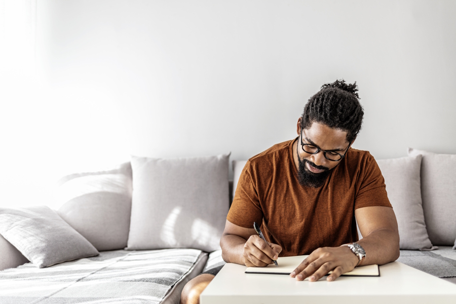 man sitting at a table writing