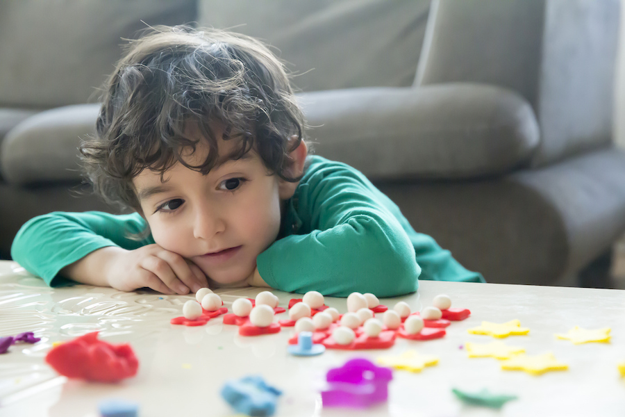 a child explores with clay in a Montessori-inspired playroom
