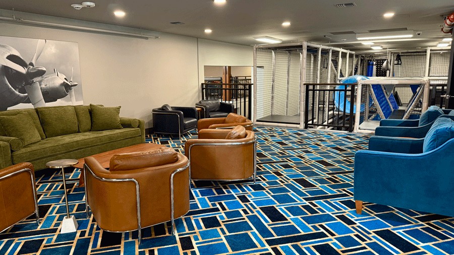 upstairs lounge at the indoor playground where adults can sit while kids play on the double-decker playground