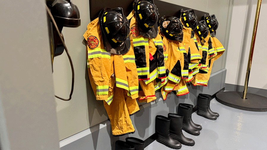 firefighter costumes hanging in the fire station of Tiny Town at Nick's Magnificent indoor playground