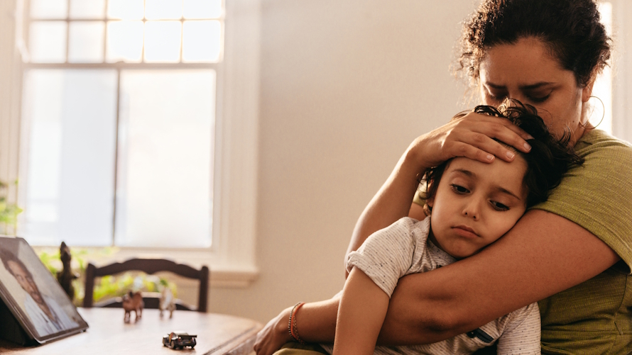 Mom holding sick kid