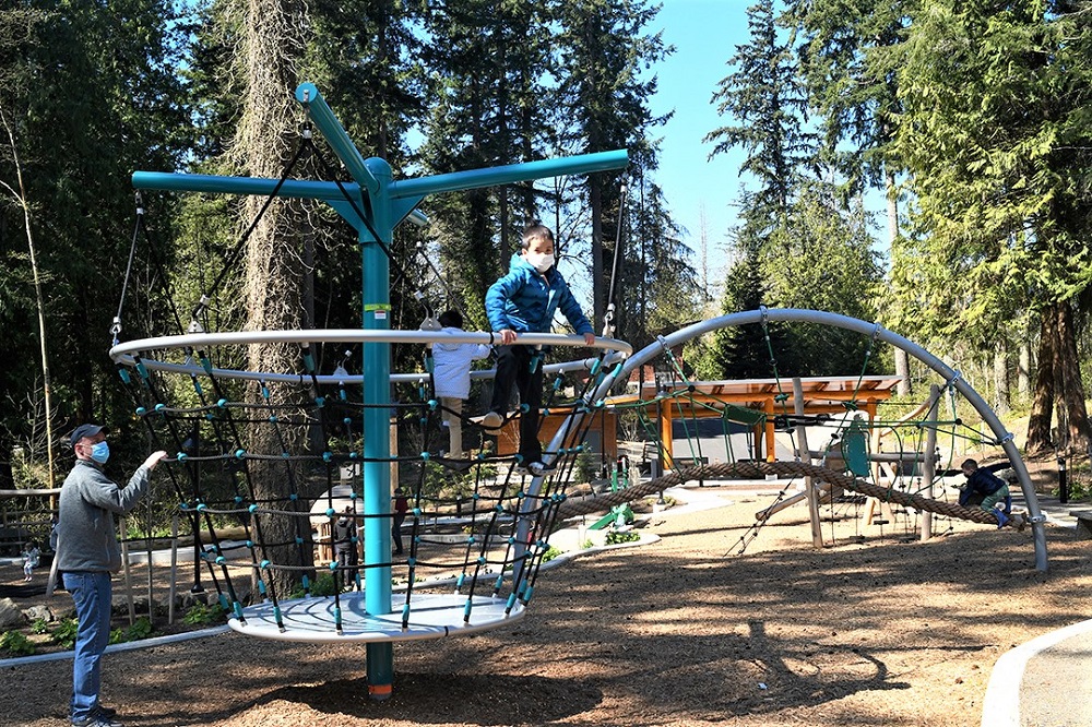 Spinning rope climber bucket feature at new Suquamish Shores Natural Play Area