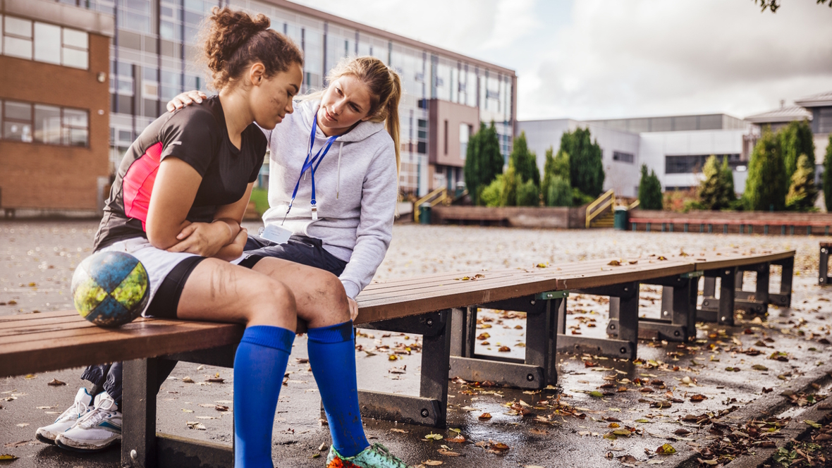 Athletic trainer helping support a high school athlete