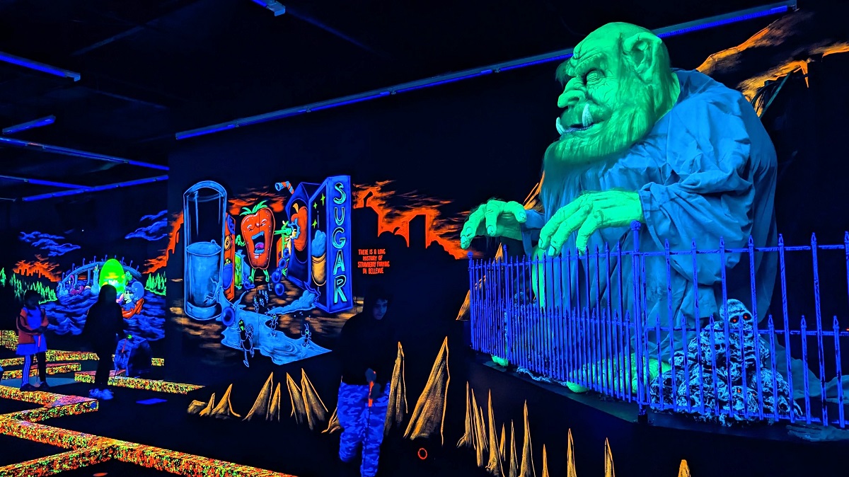 View of the blacklit mini golf course at indoor Monster Mini Golf Bellevue a new Seattle-area entertainment venue catering to families