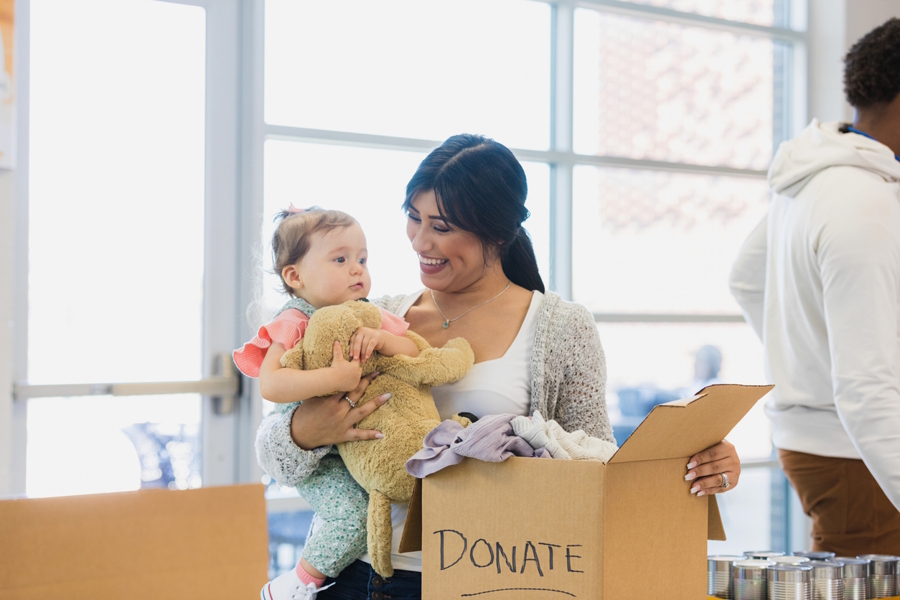 Mom and baby donating clothing