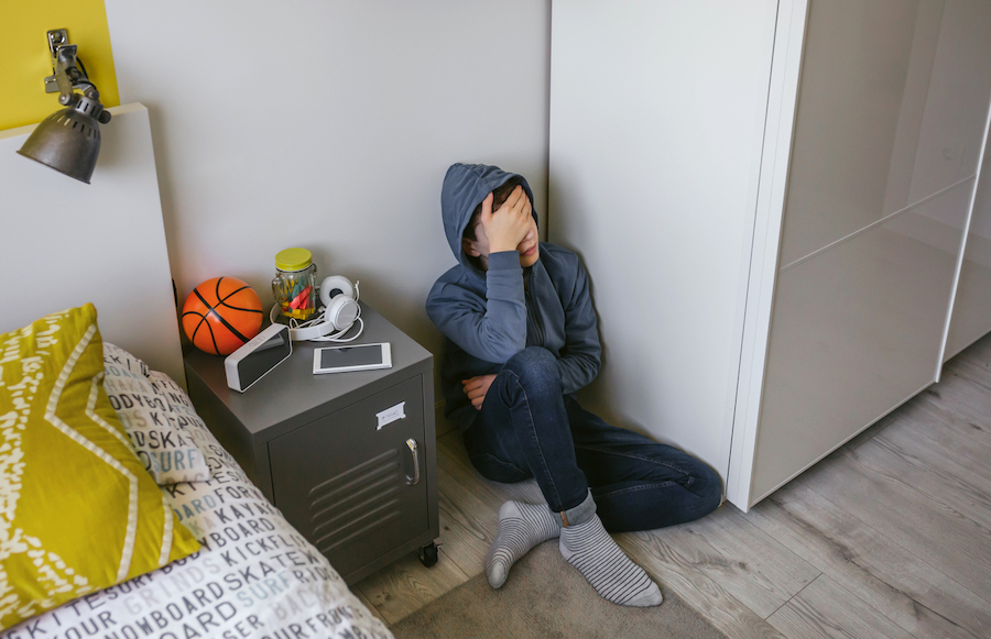 teen in bedroom experiencing burn out and overwhelm in the winter
