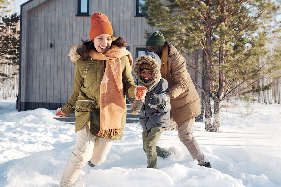 family having fun in the snow together to combat winter burnout