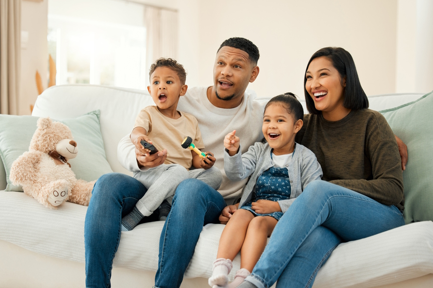 Family watching tv on a couch