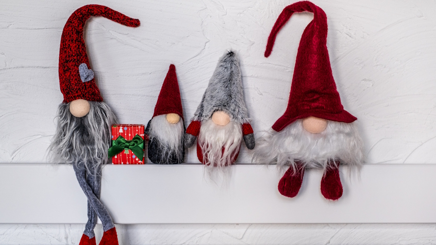 four gnomes sitting on a mantel are an elf on the shelf alternative