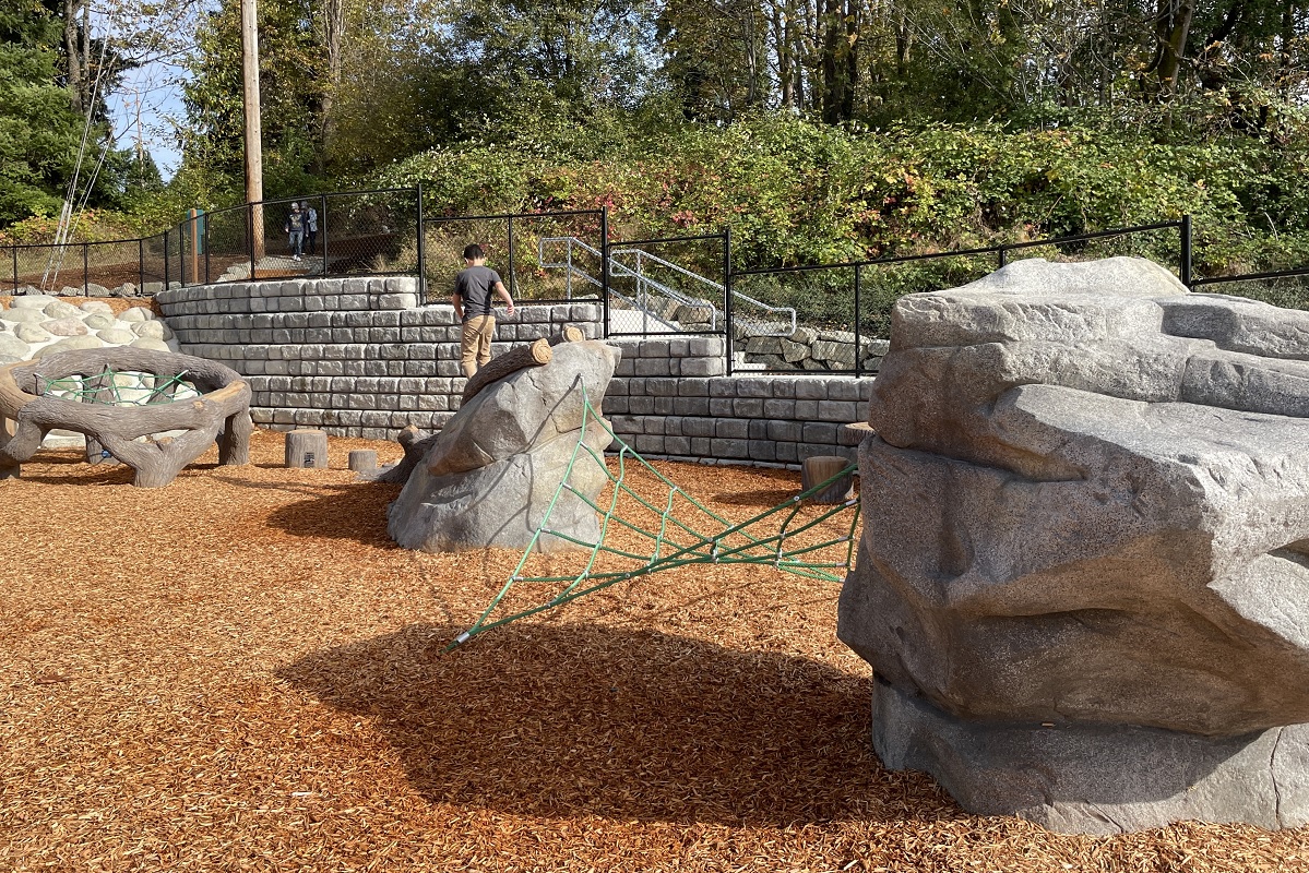 A 9-year-old boy explores the sculptural play equipment at the new playground at Bellevue’s Newport Hills Woodlawn Park near Seattle