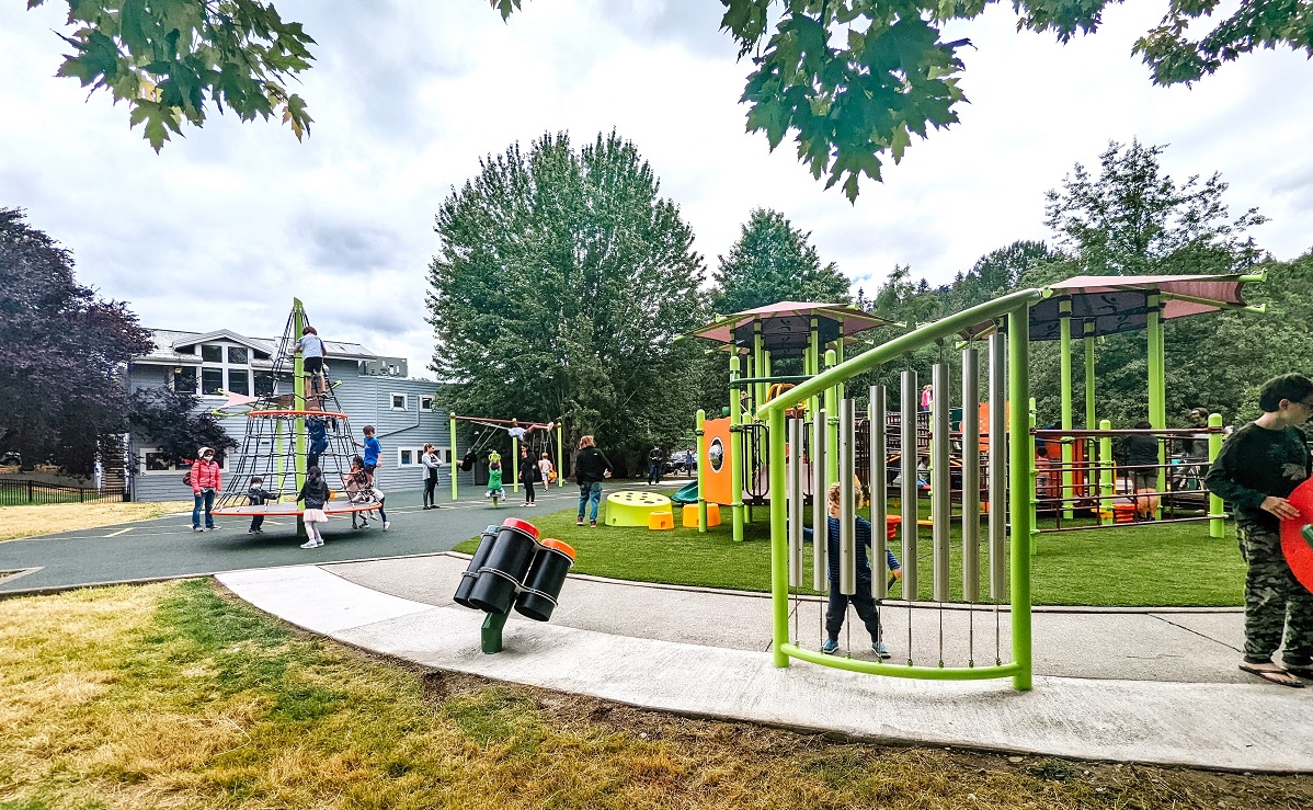 Playing on the musical chimes at the new Train Park playground at Mercerdale Park on Mercer Island which offers several musical play elements