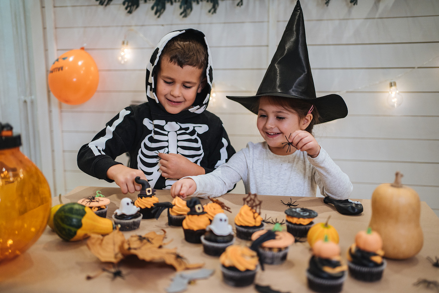 kids helping with Halloween cupcakes