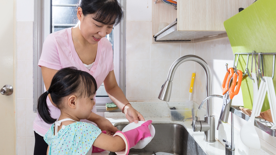 Mom and young daughter doing chores together