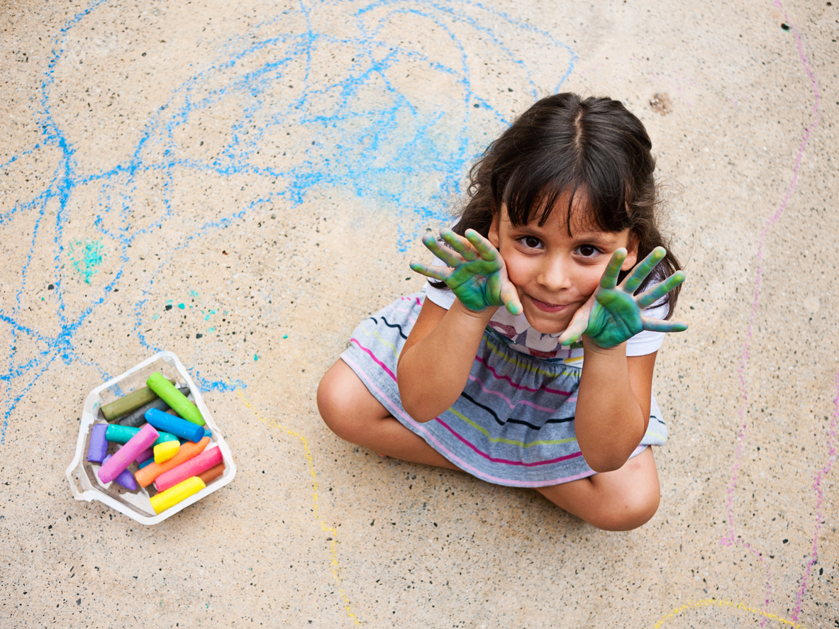 a child plays with sidewalk chalk which makes a great birthday party favor