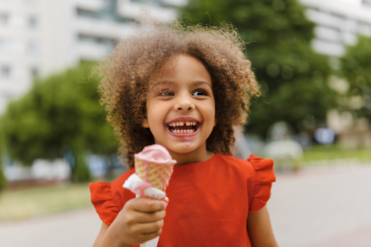 a child enjoys a birthday ice cream cone