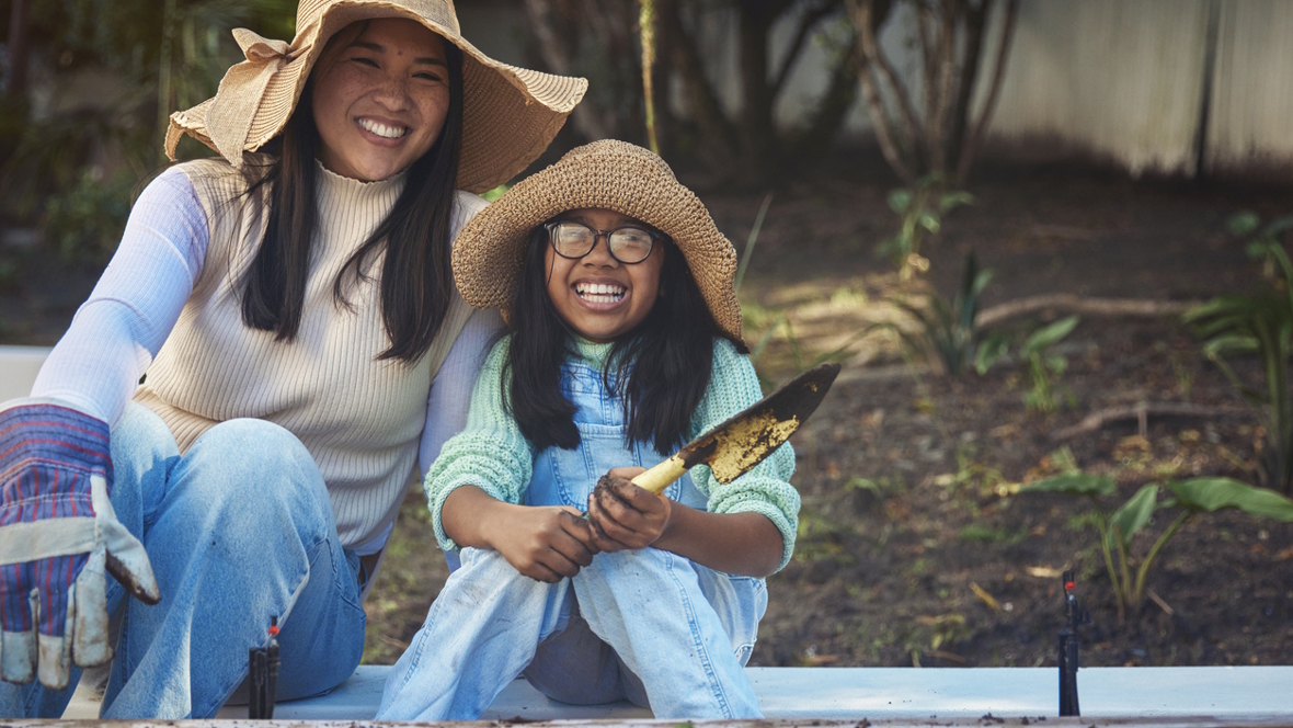 mom and daughter working together in a garden