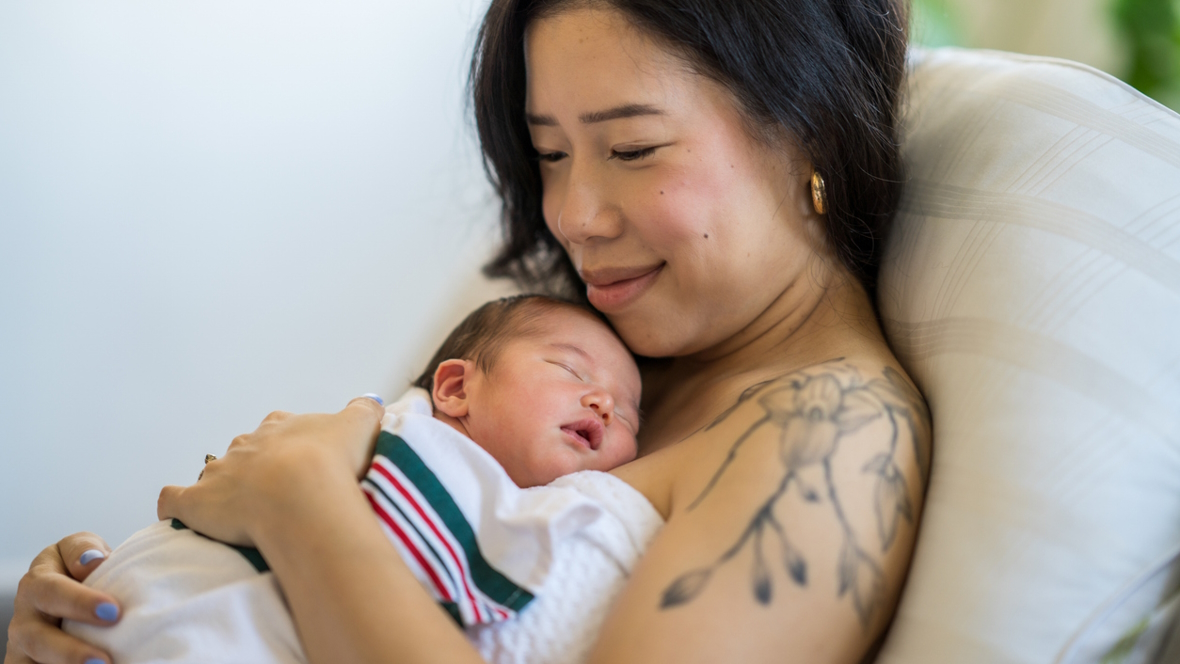 mom holding a newborn baby popular baby names 2024