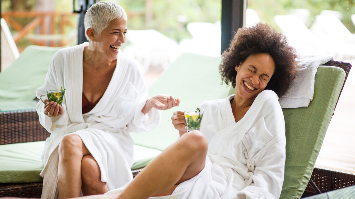 two women at a spa laugh and relaxing