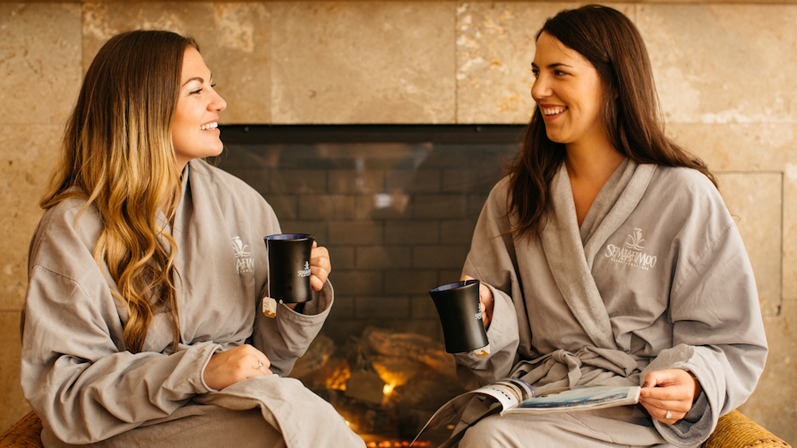 Twp women in robes sitting and drinking tea at Semiahmoo resort