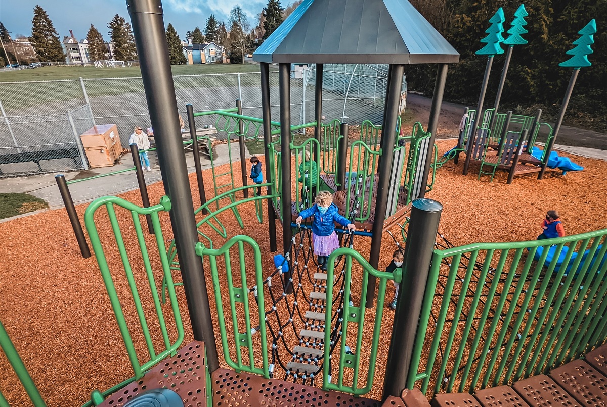 Overview of new play structure a series of towers and bridges and climbers at West Seattle’s Fairmount Playground