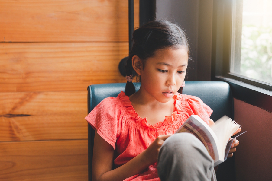 girl reading a book about money management