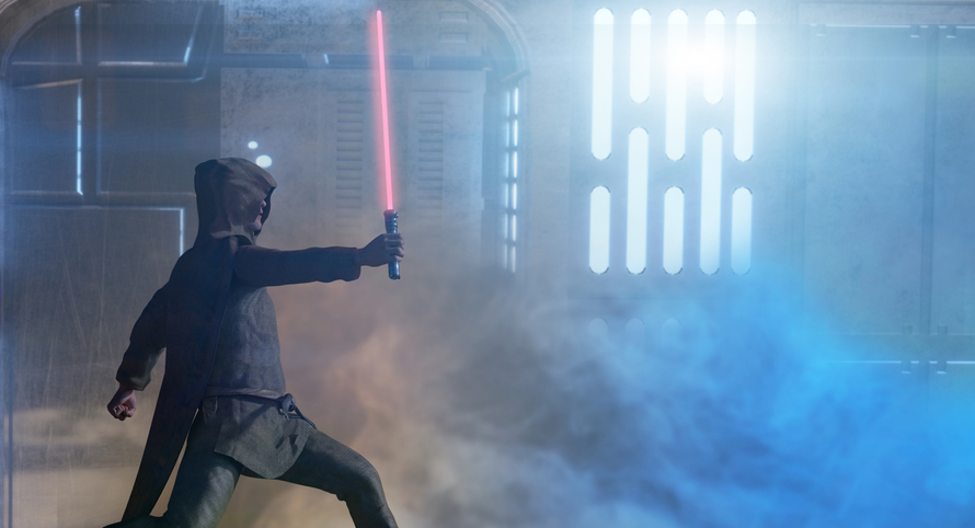 Person in a star wars costume holding a light saber