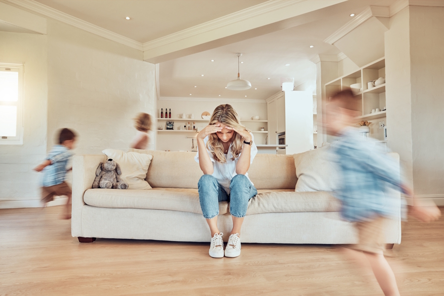 mom with kids running around her feeling parental burnout
