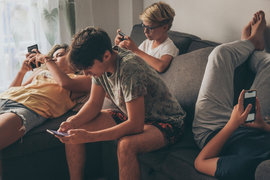 The Anxious Generation group of teens using their smart phones