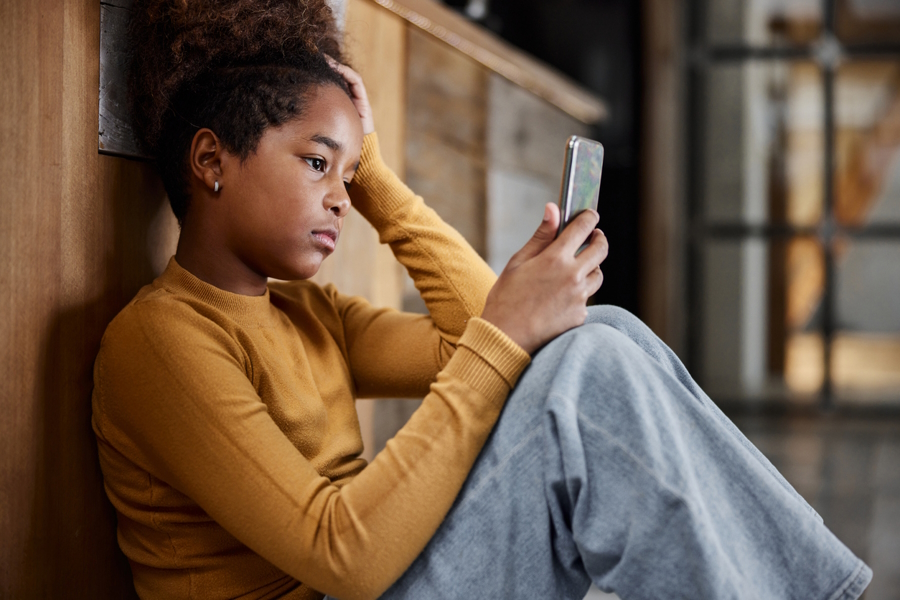 Girl looking at a smart phone part of the anxious generation